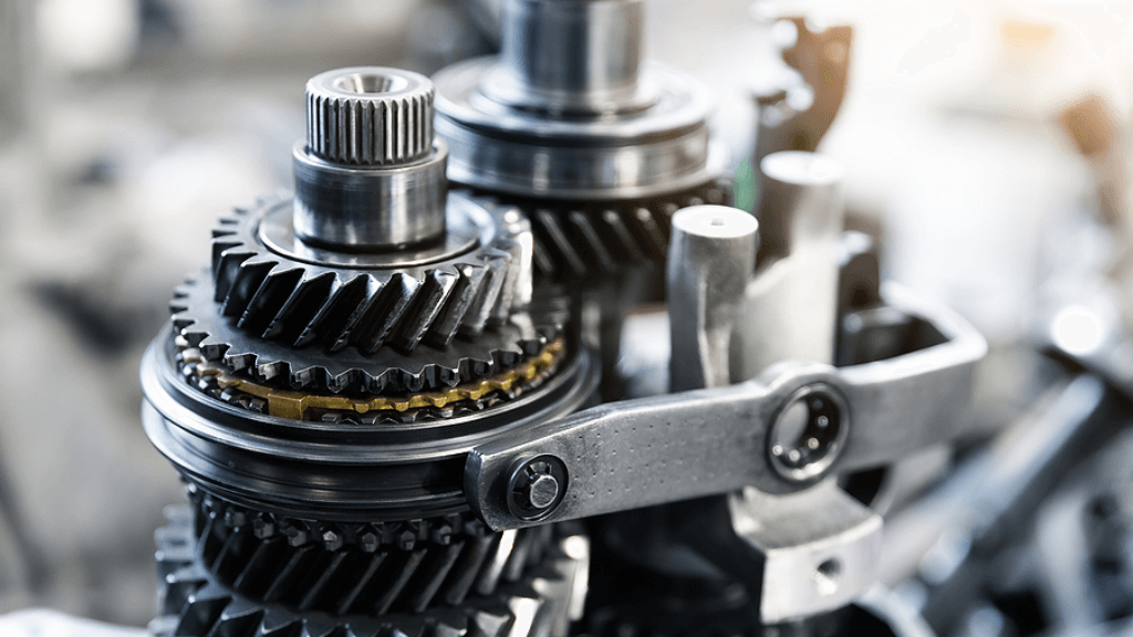 Transmission Replacement | Rowes Garage Inc. in Corinth, ME. Closeup image of a car transmission gears and other transmission components.
